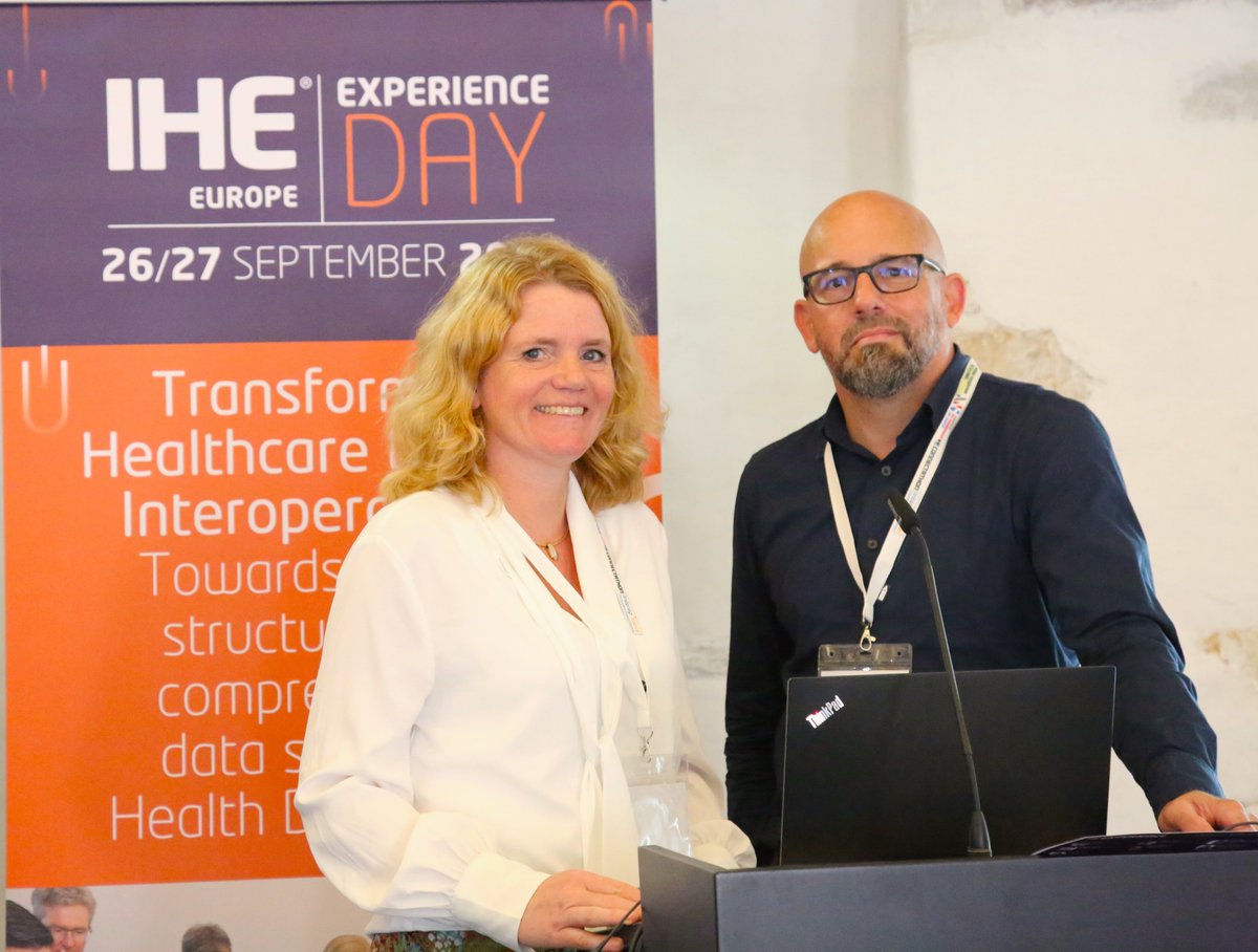 IHE_Europe's tweet photo. Arianne van de Wetering and Victor van Hagen from @Nictiz told a packed audience at the #IHE Experience Day, how little more than a year on from last #Connectathon Healthcare in the Netherlands is being revolutionised. https://t.co/m12o4o60og