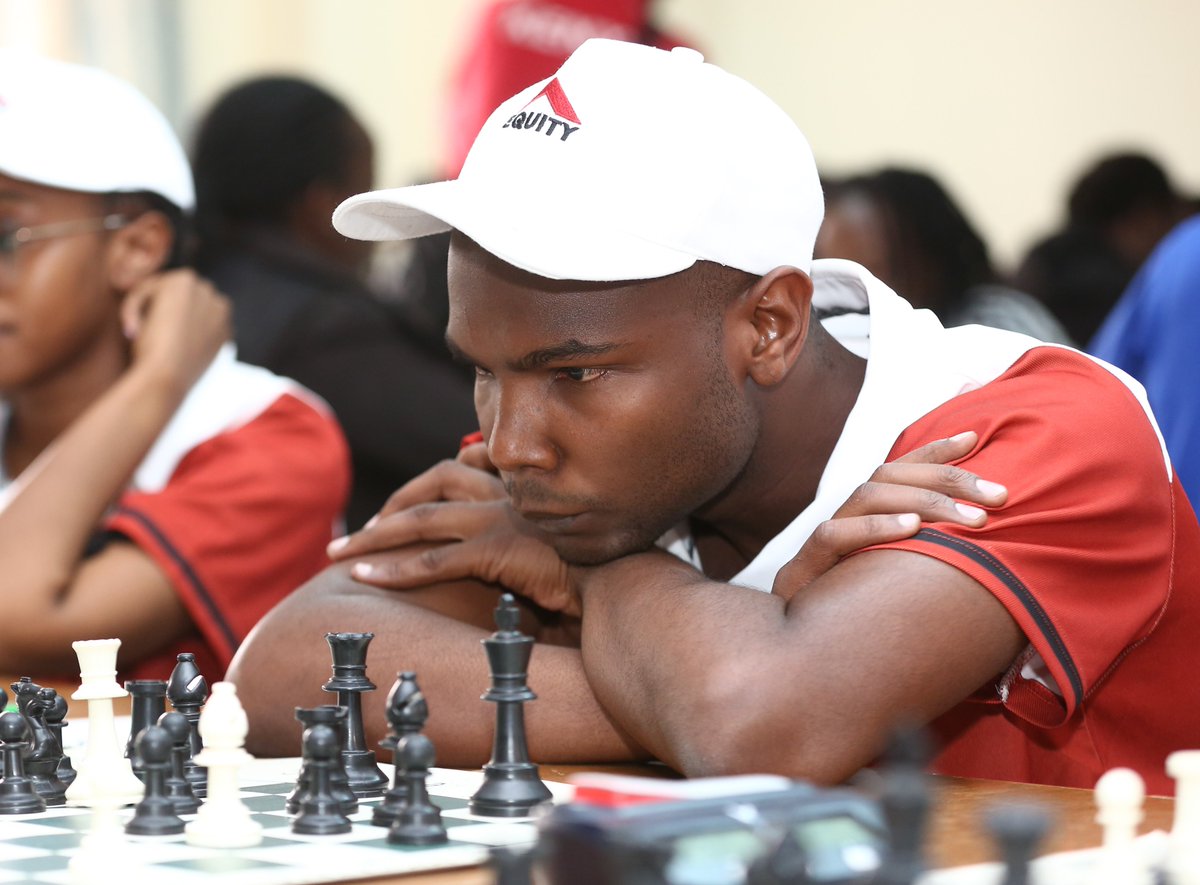 KeEquityBank's tweet image. Equity’s Hugh Miskiko (right) faces off against Mercy Cherono of Black Knights Chess Club, as teammate Matilda Glenda (centre) looks on. 
#EquitySports