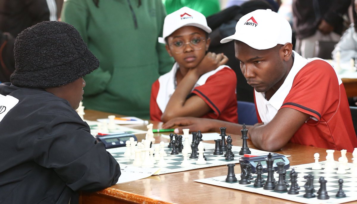 KeEquityBank's tweet image. Equity’s Hugh Miskiko (right) faces off against Mercy Cherono of Black Knights Chess Club, as teammate Matilda Glenda (centre) looks on. 
#EquitySports