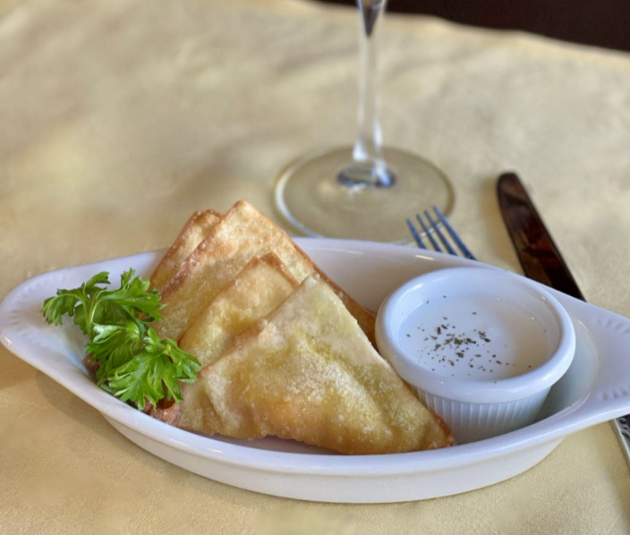 It's the season to enjoy anything and everything butternut squash. Our kadoo turnovers are a great way to start your dining experience. They are sweet and savory with the perfect crunch, paired with our garlic yogurt for dipping.