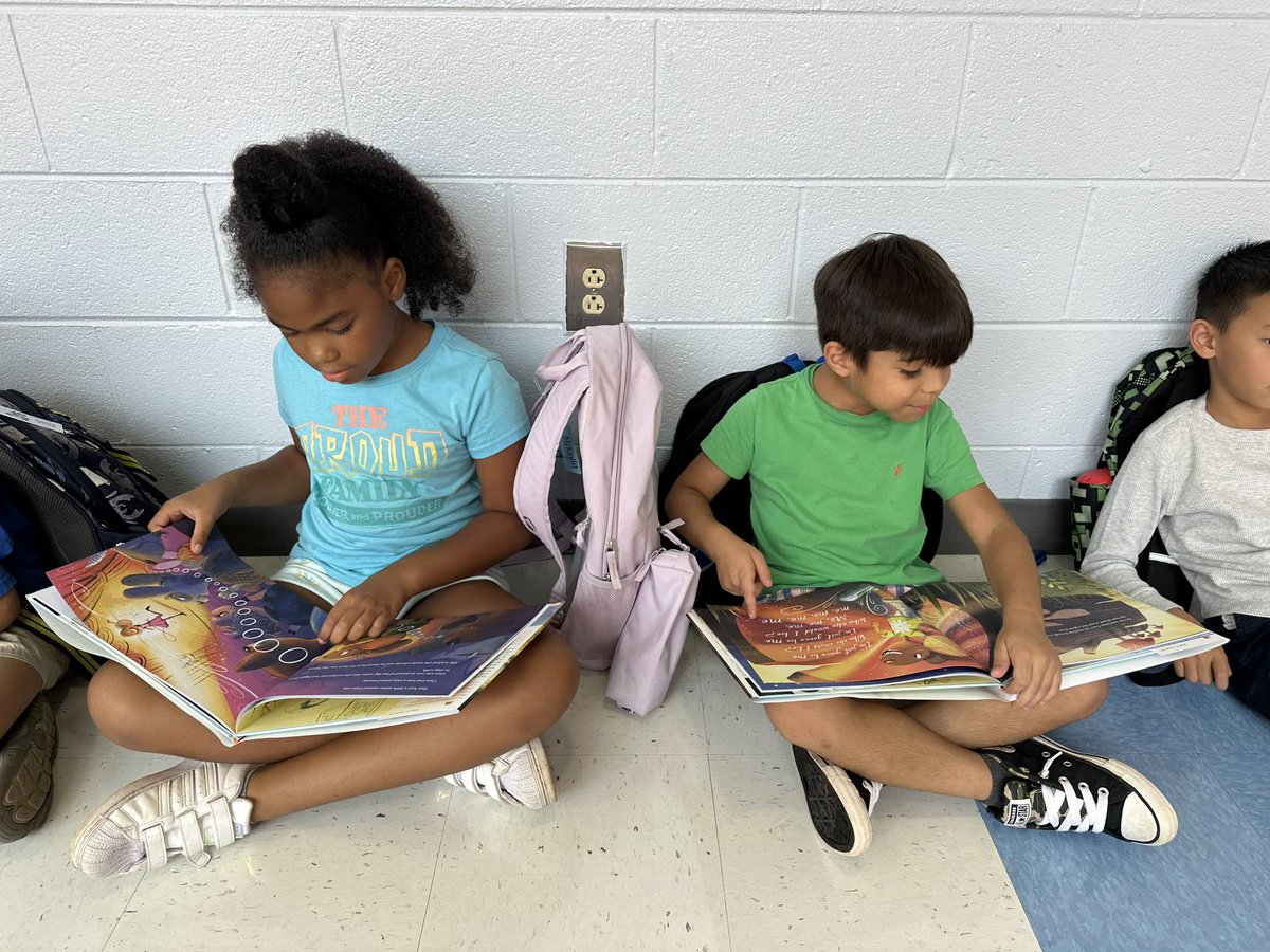 burroughbunch's tweet photo. Couldn’t even wait to get home to enjoy their new books!!! We are SO THANKFUL for the fun things we get to do at NPE! Thank you @idinamenzel and @CaraMentzel for the signed copies for our students! https://t.co/qYe46WaLsz