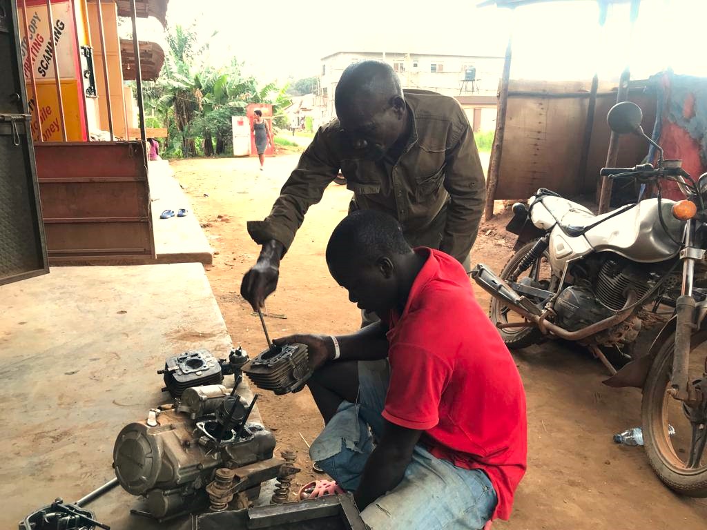 BHMupdates's tweet photo. Meet Henry with Mzee Rajab - his trainer in Motorcycle Repair in Nangabo. Henry is becoming a great mechanic for body damage, servicing, tyre problems and more. Henry is originally from Sironko  and will soon visit his mother after over 4 years.
 #transition #restoration https://t.co/h66imxUOK4