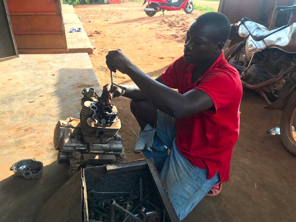 BHMupdates's tweet photo. Meet Henry with Mzee Rajab - his trainer in Motorcycle Repair in Nangabo. Henry is becoming a great mechanic for body damage, servicing, tyre problems and more. Henry is originally from Sironko  and will soon visit his mother after over 4 years.
 #transition #restoration https://t.co/h66imxUOK4
