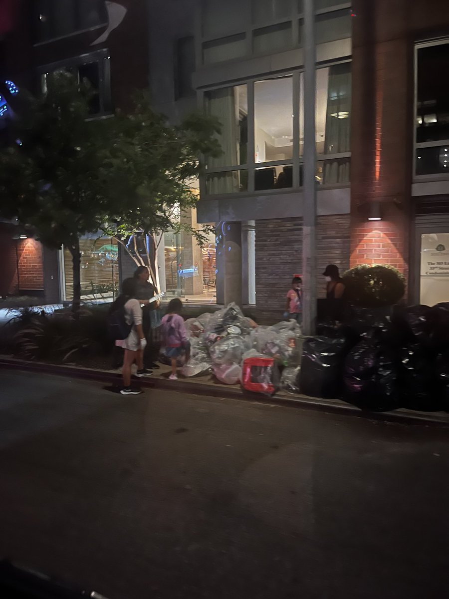 Migrant children on the streets of New York last night combing through trash for bottles and cans they can exchange for money