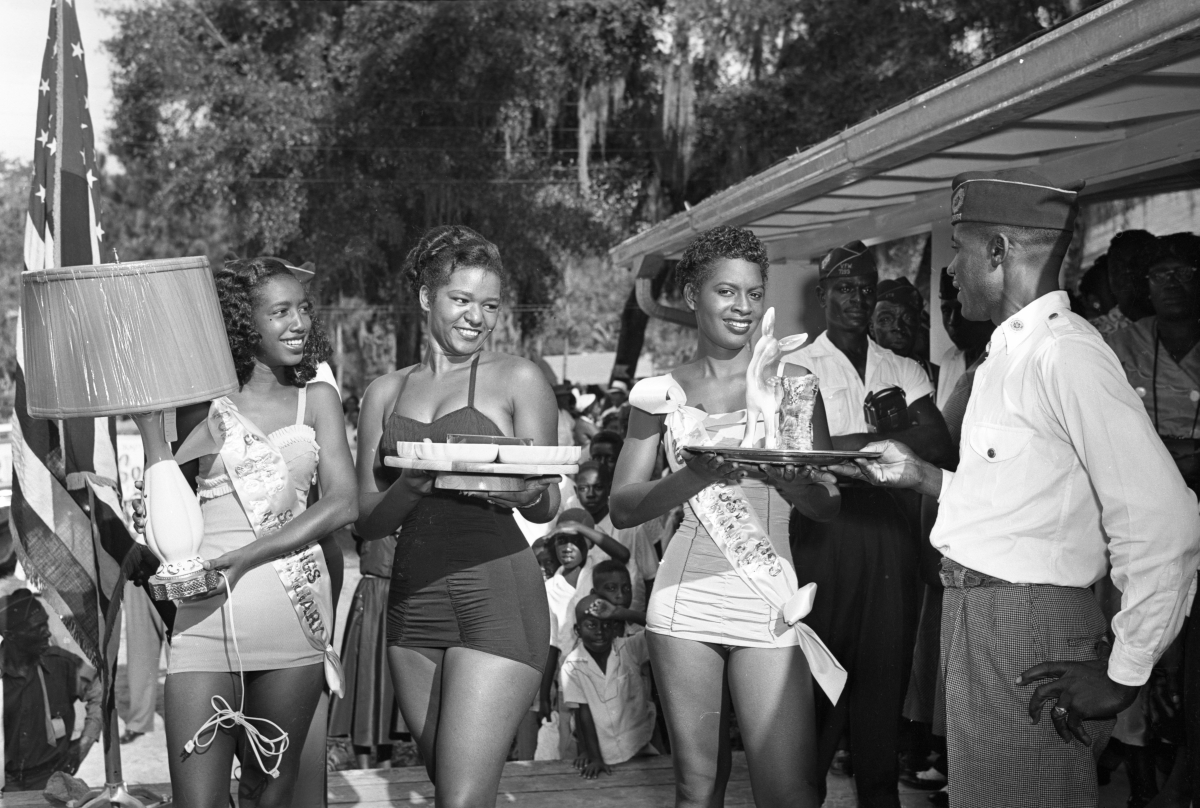 FLMemory's tweet photo. Miss Paradise Park pageant winners receive prizes in this photo dating to September 6, 1954. Earlene Archie and Gloria Johnson Pasteur are among the finalists pictured. #FloridaMemory. Link: https://t.co/JjHEocNuJW. https://t.co/TnNl89fUrR