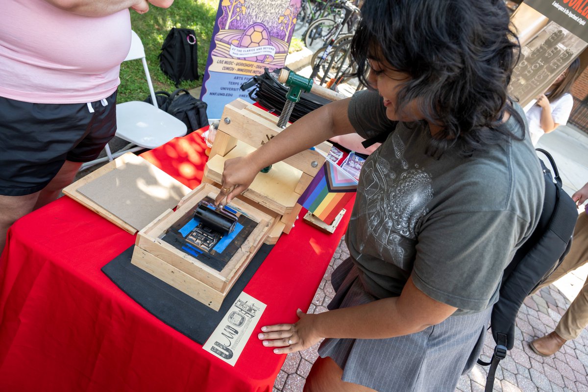 UMDEnglish's tweet photo. Bookmark printing with @umd_BookLab at #NextNOWFest 2023! Participants used a letterpress modeled on the historic Gutenberg screw press to create hand-printed bookmarks. Shout out to the amazing BookLab and @TheClariceUMD teams for making this activity possible. #ArtsForAll https://t.co/jGpOuypgBP