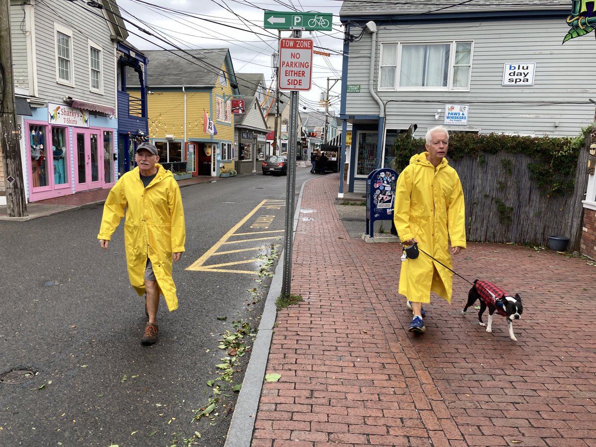 Is is wet and windy in Provincetown this morning as residents David Geiger, left, and John Lamb walk their dog Cooper.