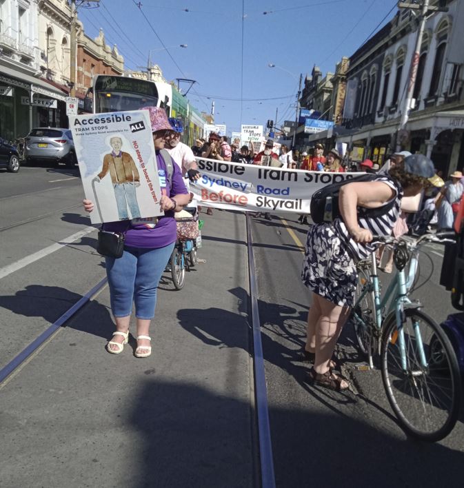 kcIMT122's tweet image. I took part in the rally today, Sydney Rd Brunswick.

The 19 tram line has no accessible stops for 5.5km, so disabled ppl on scooters etc are forced to use the train.

But the train line is about to close while they do LXR, leaving disabled ppl stranded.

#AccessibleForAll