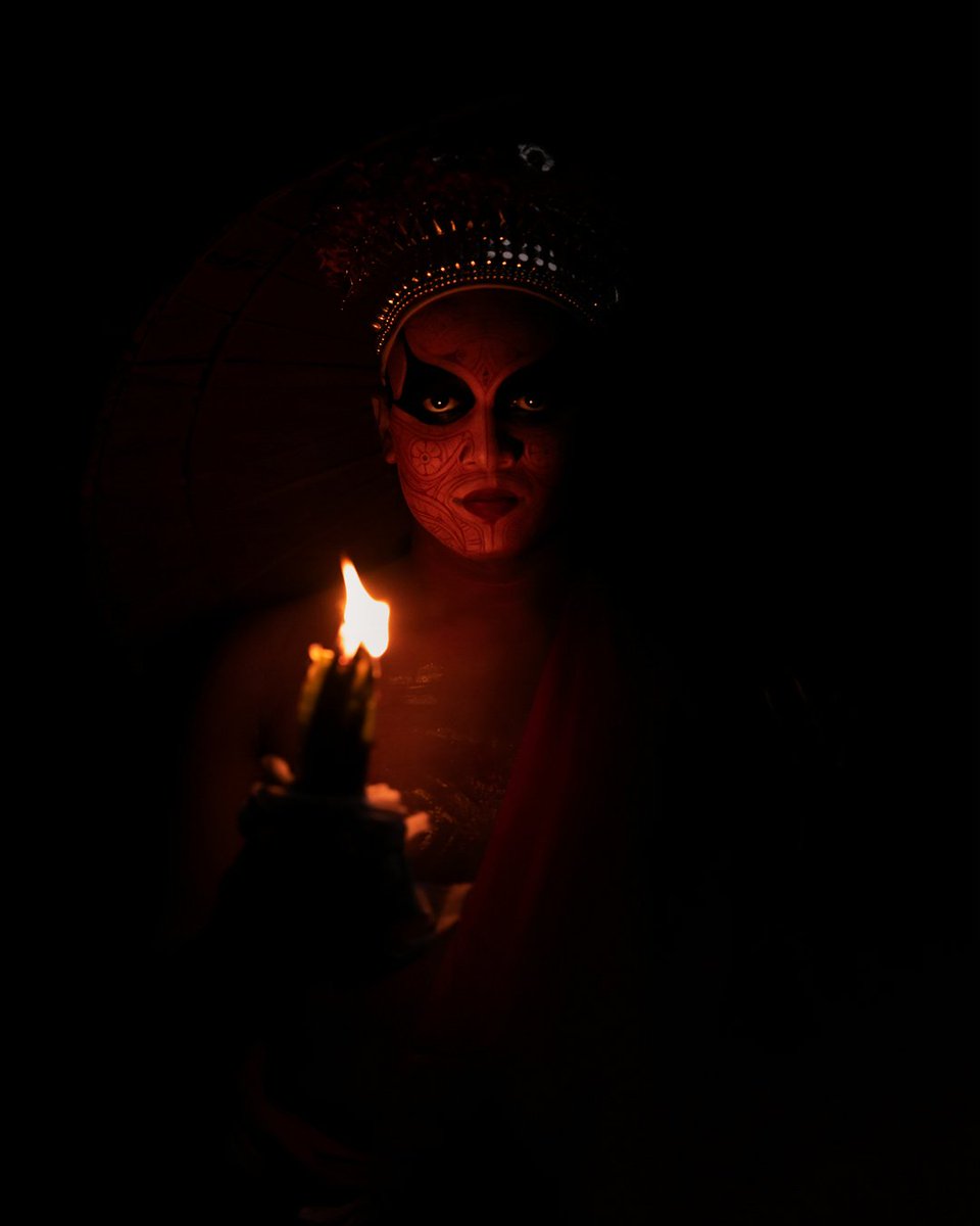 8bit_monk's tweet photo. In the dead of night, a theyyam performer returns home with a flickering fire, illuminating his painted face. Stripped of his deity costume, he's on a journey from god to man, in a mesmerizing play of darkness and intensity. https://t.co/3l8sNue5mg