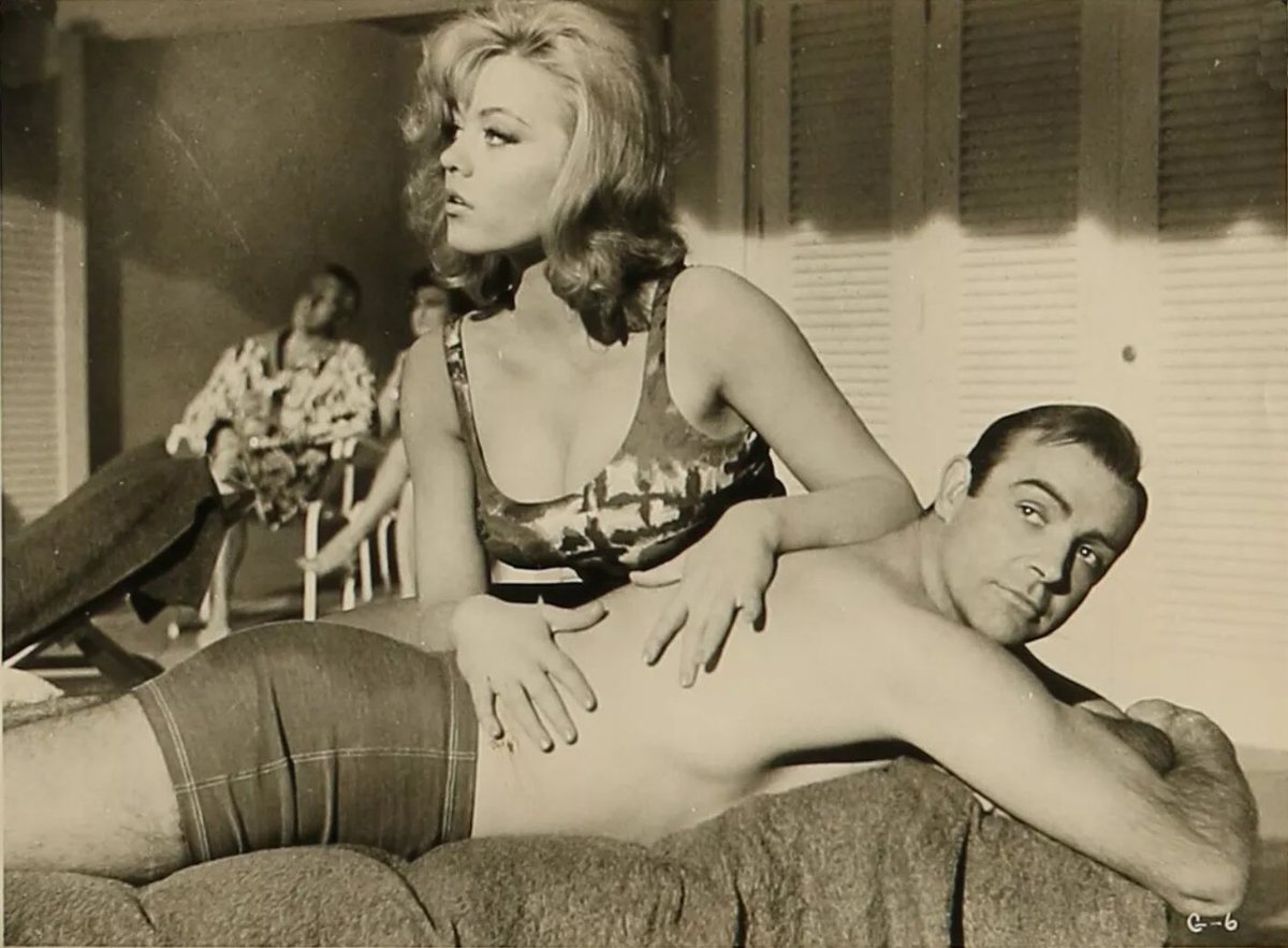 SteJWi22's tweet photo. OTD in 1964, the gala premiere of #Goldfinger took place. 
It marked the 1st. film role for 21 yr old #MargaretNolan launching a career that spanned many films.
She was the face of the film on posters, merch &amp; in the title sequence. The small role of ‘Dink’ was part of the deal. https://t.co/dxkBKH9ugl
