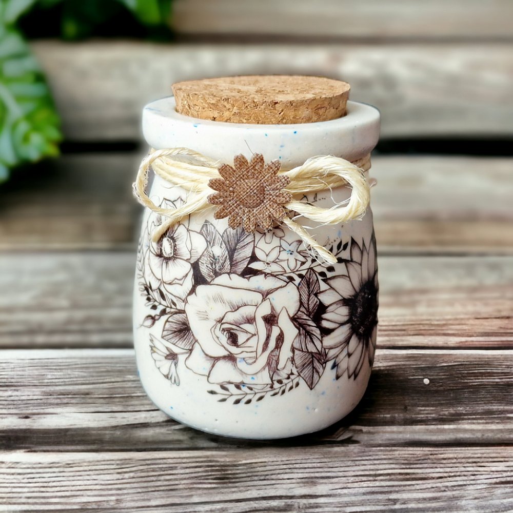 A small terrazzo jar made with cream and blue Jesmonite. I have added a pretty black floral decal, twine and a fabric flower with a Cork stopper lid.

#terrazzopot #jesmonitehomedecor #jesmonitehomeware #terrazzo #flowerpot #twinewrapped #britcraft #MHHSBD #shoplocal #shopsmall