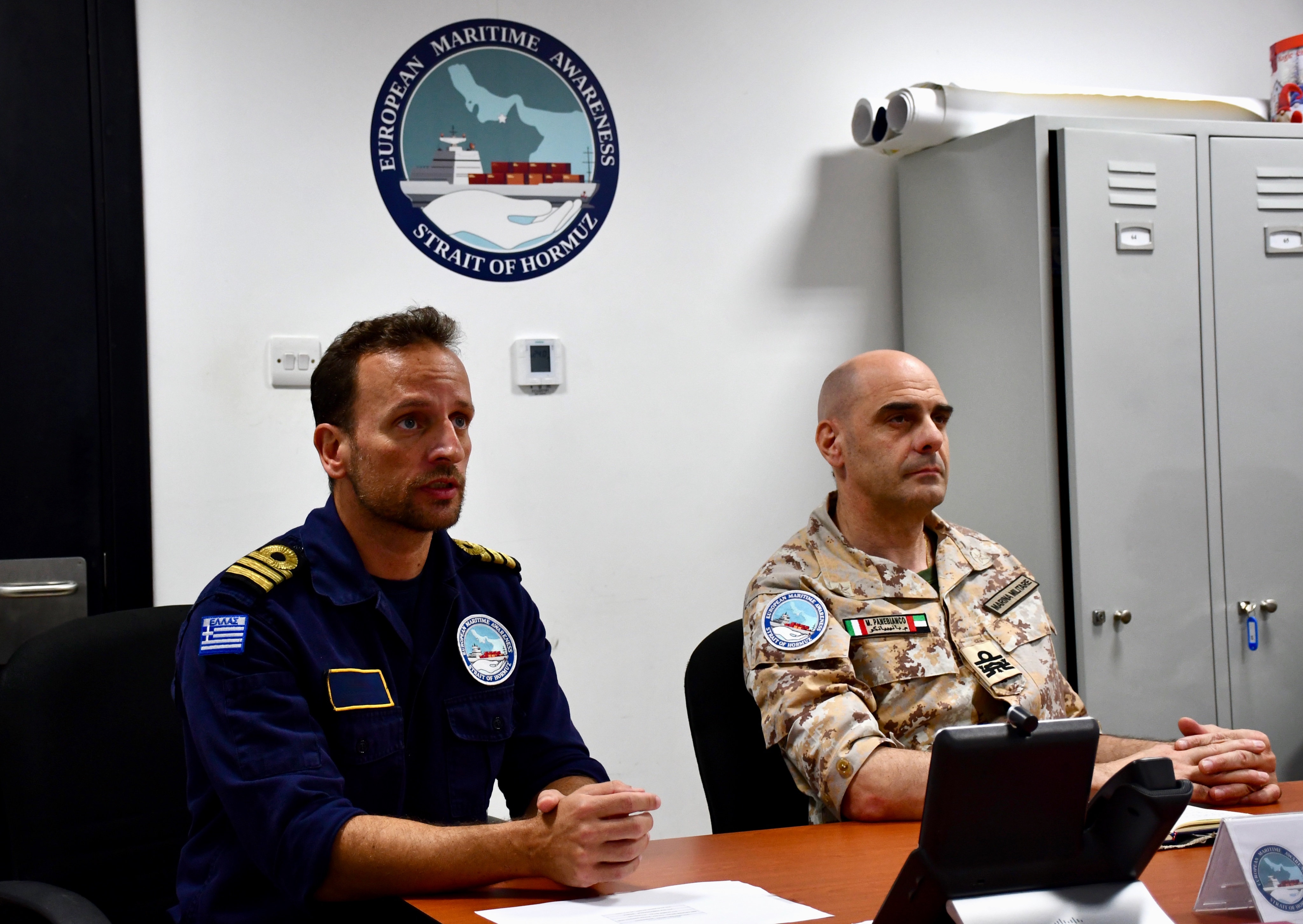 Force Commander Rear Admiral Panebianco (right) and Greek BattleWatch Captain (left) during the VTC. EMASOH logo in the back