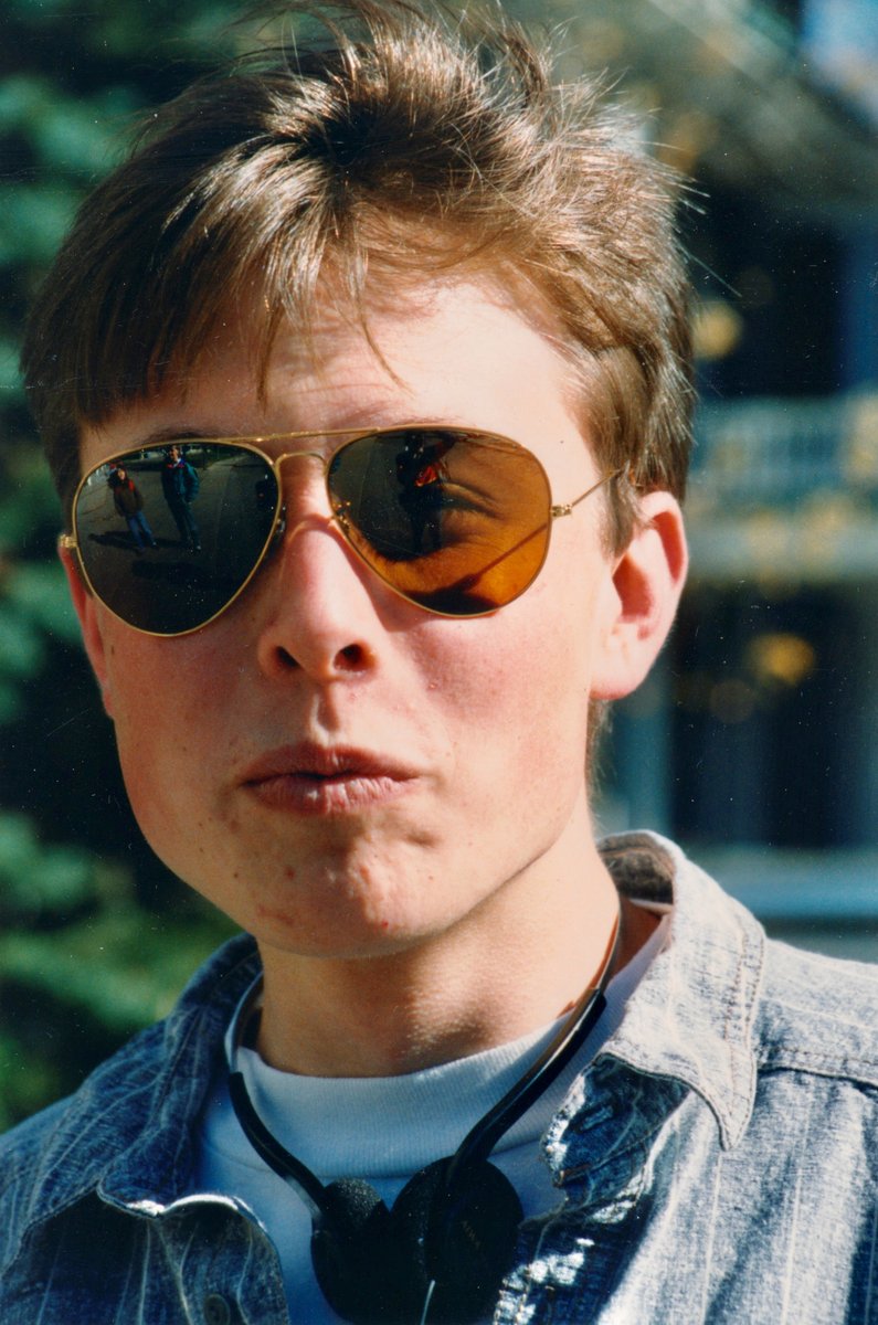 Amazed to discover this old photo of @elonmusk from when we were together at @queensu circa 1990. That is me reflected in his left lens, taking the photo, and my friend @BrettEHouse reflected in his right lens. I don't actually remember meeting Elon, but I must have!