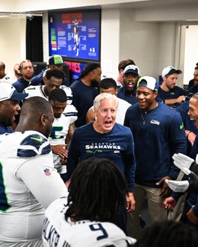 A photo of Pete Carroll and the team in the locker room.