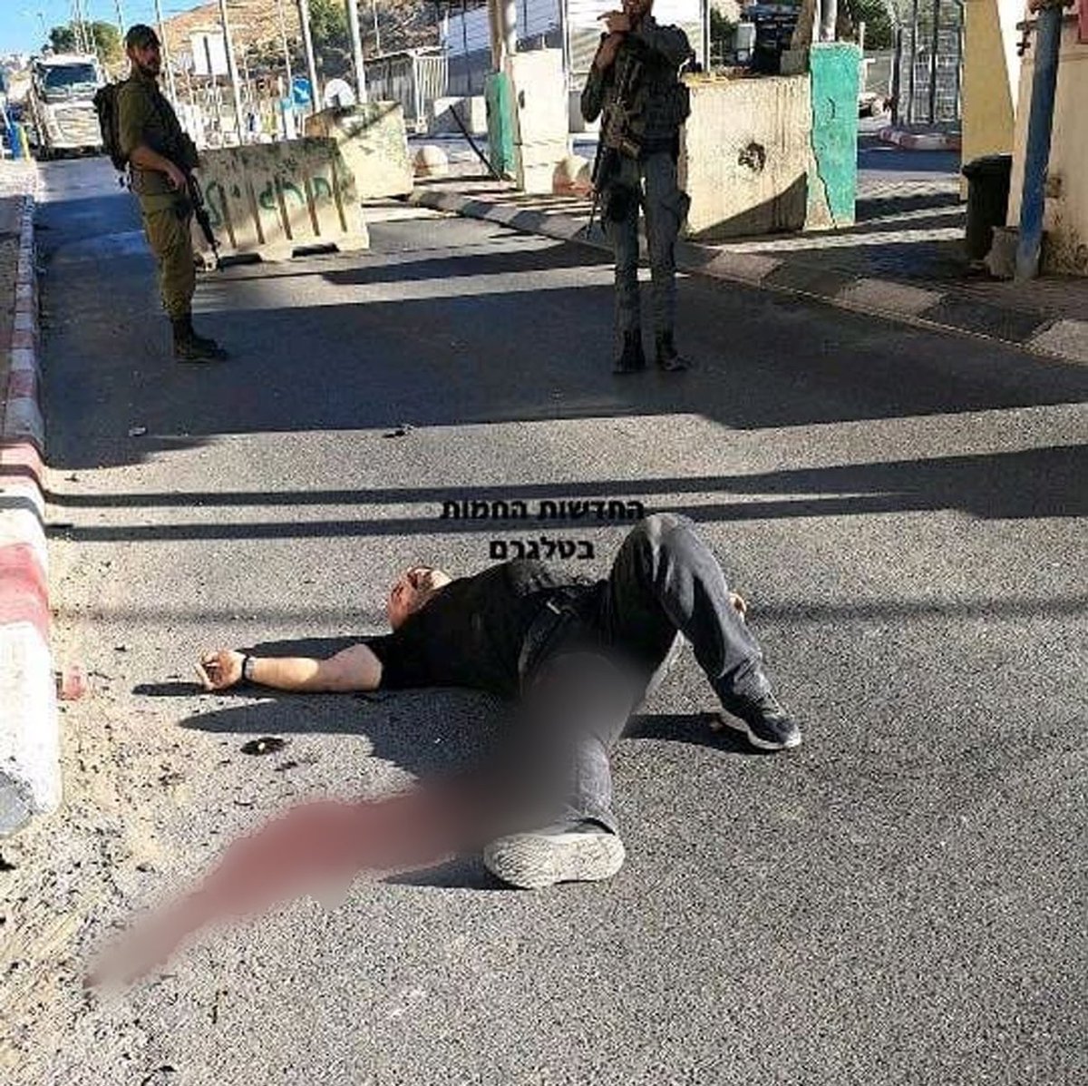 swilkinsonbc's tweet photo. Contrary to the israeli lies, the Palestinian man shot by israeli troops in Jerusalem had his hands behind his back: he was unarmed @QudsNen https://t.co/MIah1X0MFH