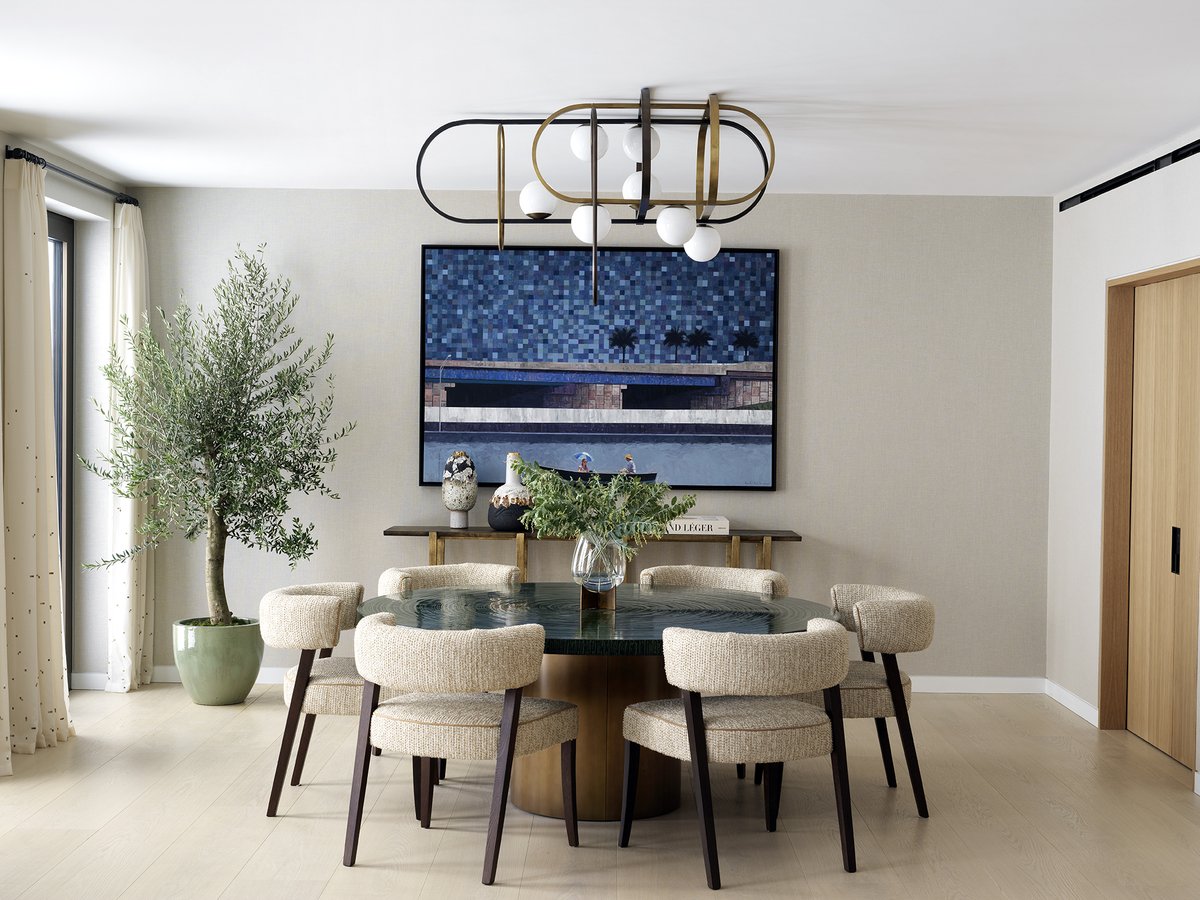 This is one of my favourite dining rooms. I feel all the different elements come together well. The custom brass-and-bronze pendant and the textured lacquer dining table are both my design. In the backdrop, a Gustavo Acosta painting injects the room with energy.