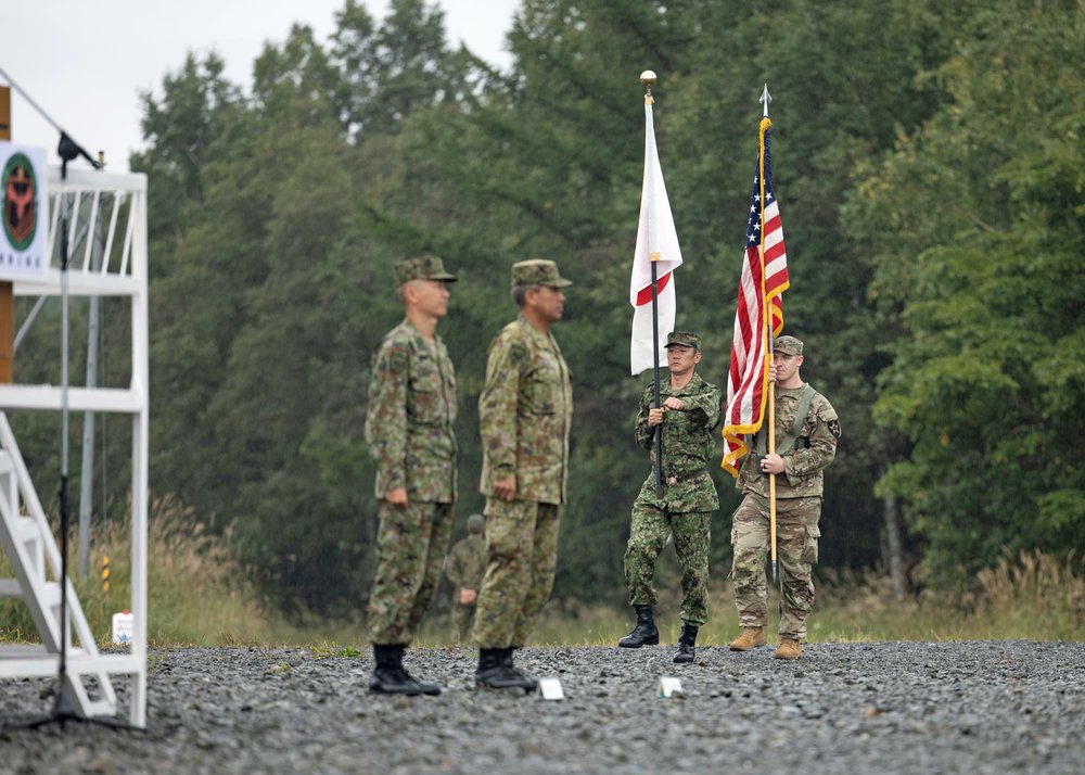 USForcesJapan's tweet photo. A U.S. Army Soldier and a member of @Japan_GSDF carry their nation's flags at the opening ceremony for #OrientShield23 at Kamifurano Training Area in Hokkaido, Japan, Sept. 14, 2023. Orient Shield is the largest bilateral field training exercise between the U.S. Army &amp; the JGSDF. https://t.co/M61Z0XBuGl