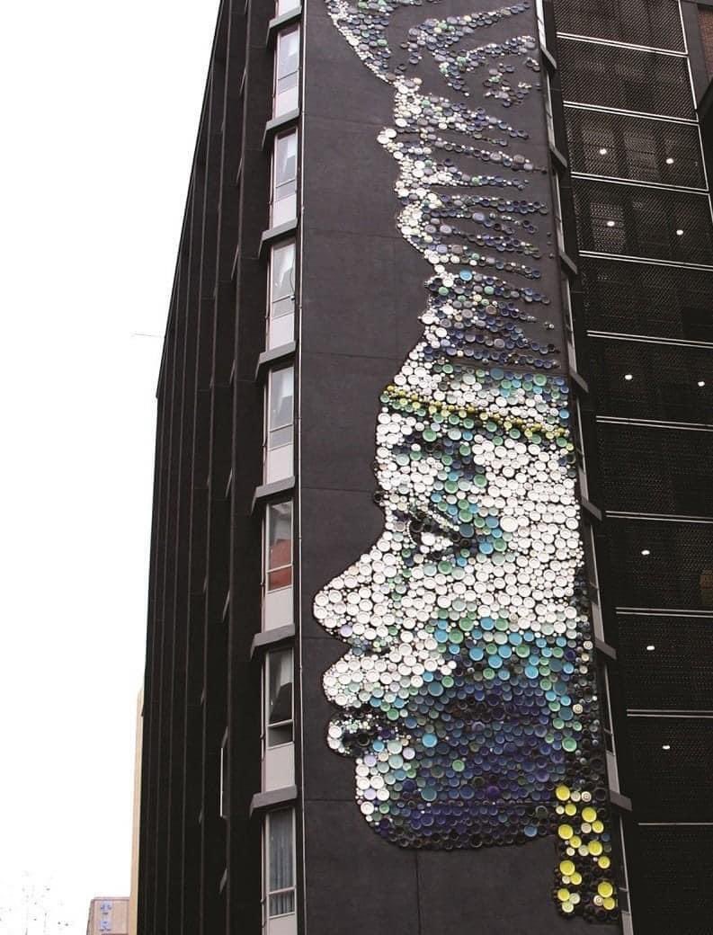 CityofJoburgZA's tweet photo. The Ndzundza/Nzunza portrait

Hannelie Coetzee’s "Nzunza" is a 10-story high mural on the side of the North City House building in Braamfontein. The artwork is named after and inspired by the history and culture of the Ndzundza-Ndebele people who lived in the area in the 17th century #JoburgHeritageMonth #HeritageMonth #ExploreJoburg ( via https://t.co/WQ01RFQHY3) ^ NB