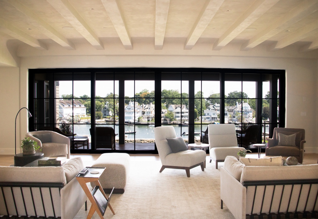 We could sit in this living room for hours soaking up the last bits of summer sun and watching boats speed by😍

This steel sliding door system measures nearly 25 feet wide, allowing for maximum daylight, providing gorgeous views of Long Island Sound all year round.