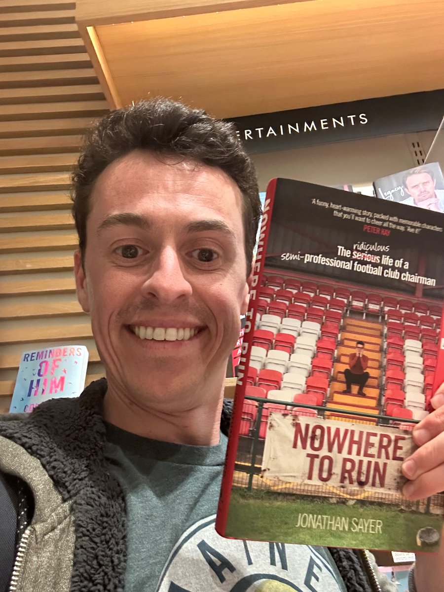 JonathanSayer1's tweet image. Back in the UK and spotted my book in a bookshop for the first time! Took a photo of myself grinning! Huge thanks to everyone who has bought a copy so far. #NowhereToRun