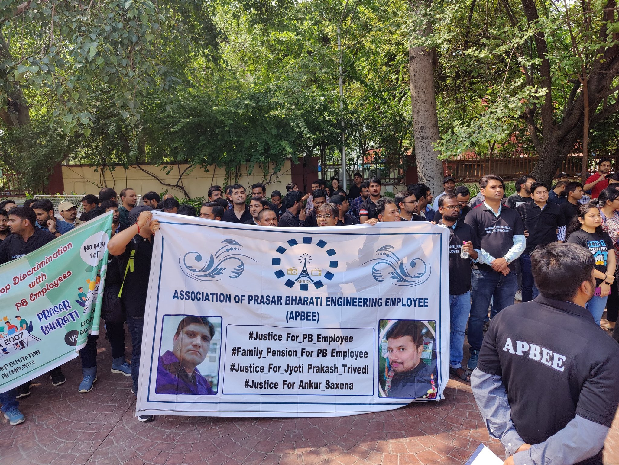 Banner showing deceased employees Jyoti Prakash Trivedi and Ankur Saxena