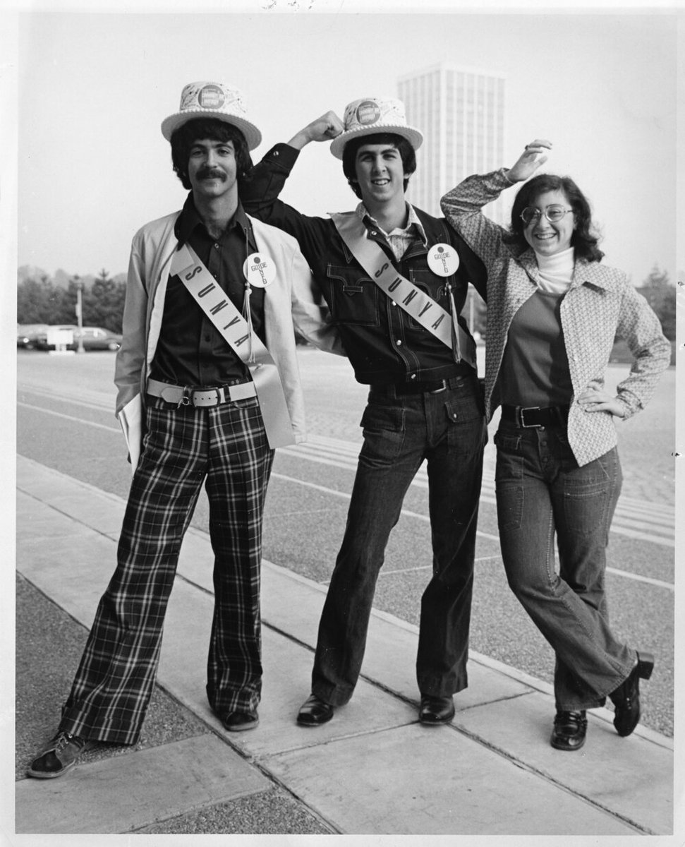 Feeling some serious vintage vibes! 😎 'Two student guides and an unidentified woman attending Community-University day, 1973, at the State University of New York at Albany uptown campus.' - University Archives #TBT #UAlbany #UAlbanyLibraries #Archives