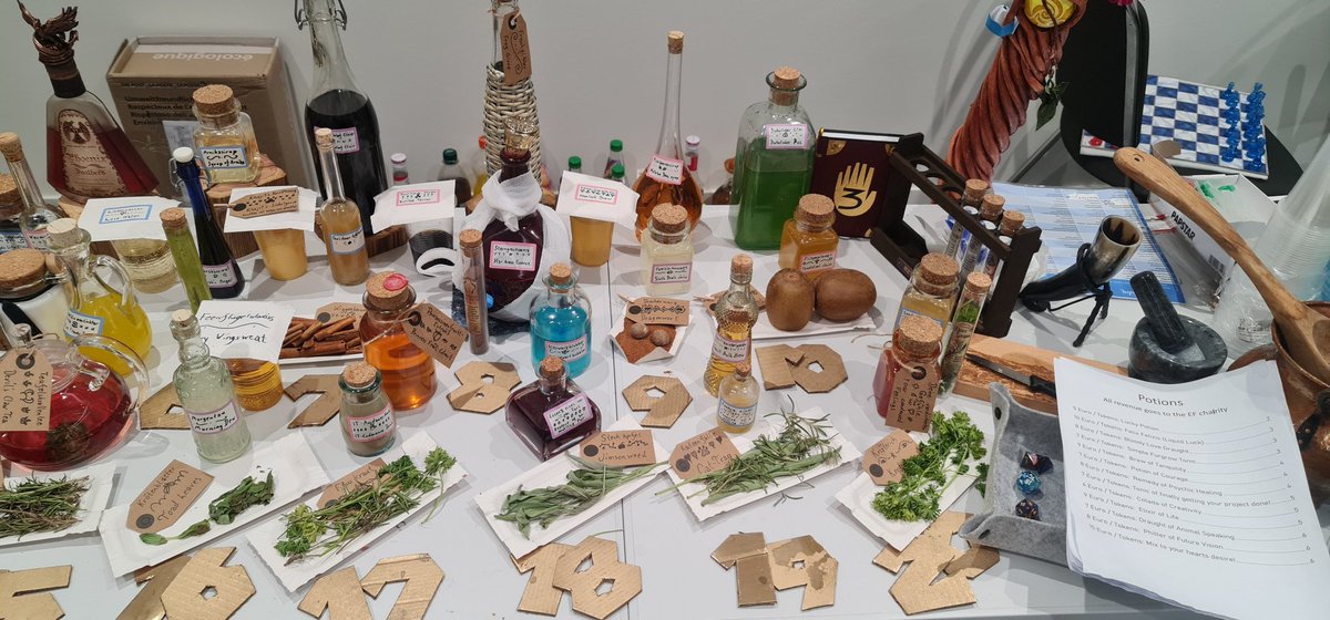 Aninok_Magnolis's tweet photo. And here's what my Bets &amp; Brews booth looked like ^¥^
Through potions and games, we got 221 Euros for the Eurofurence Charity UAnimals! Which isn't a lot compared to the whole sum, but I'll mark as a success anyway for a half-hidden, payment optional, slow turnaround booth x3 https://t.co/yJyZcM6tA0