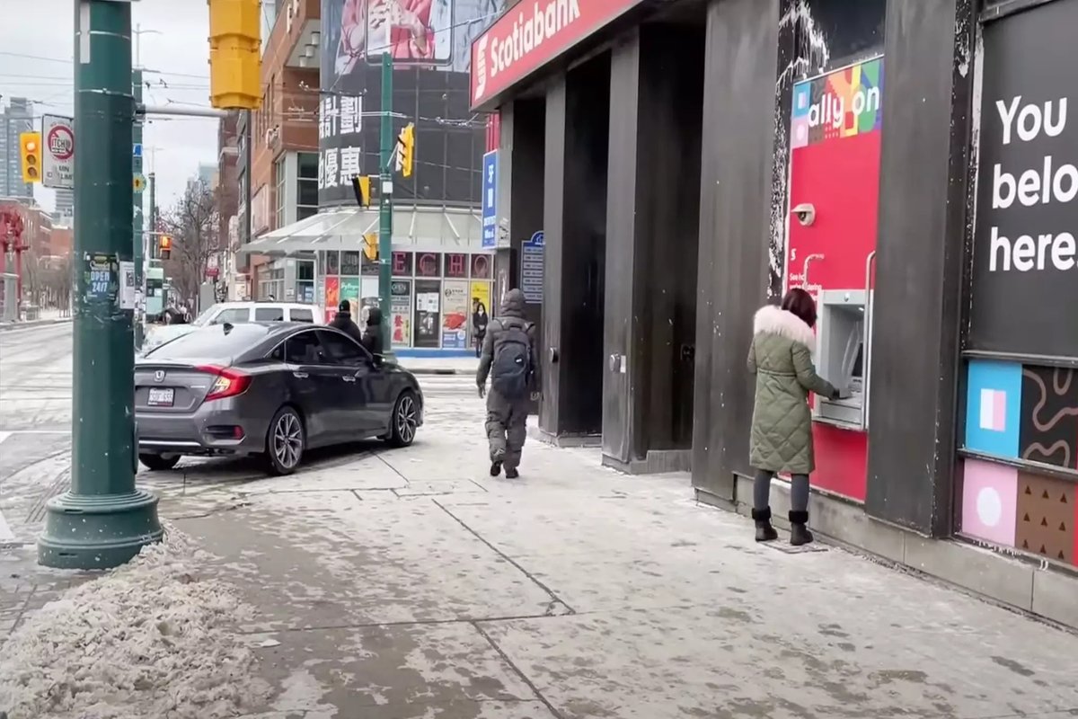 A driver parks her vehicle on the sidewalk in order to use an ATM in Chinatown (Credit: BlogTO).