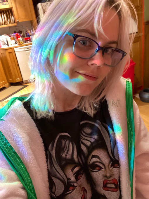 Wearing my mfc jacket and catching some rainbows from the window and a boulet brothers shirt https://t
