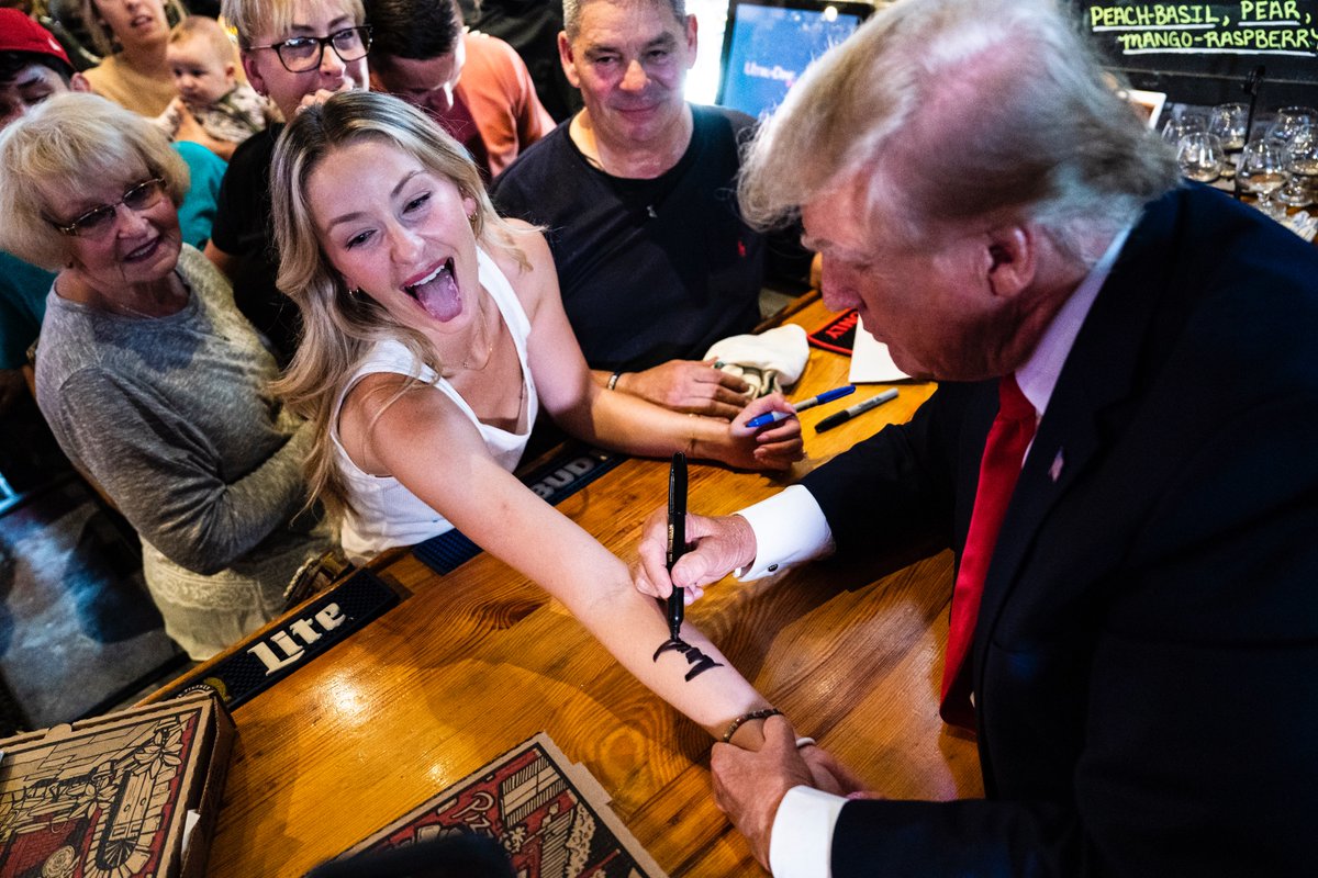 Former President Donald Trump signs autographs at the Treehouse Pub &amp; Eatery in Bettendorf, IA today.