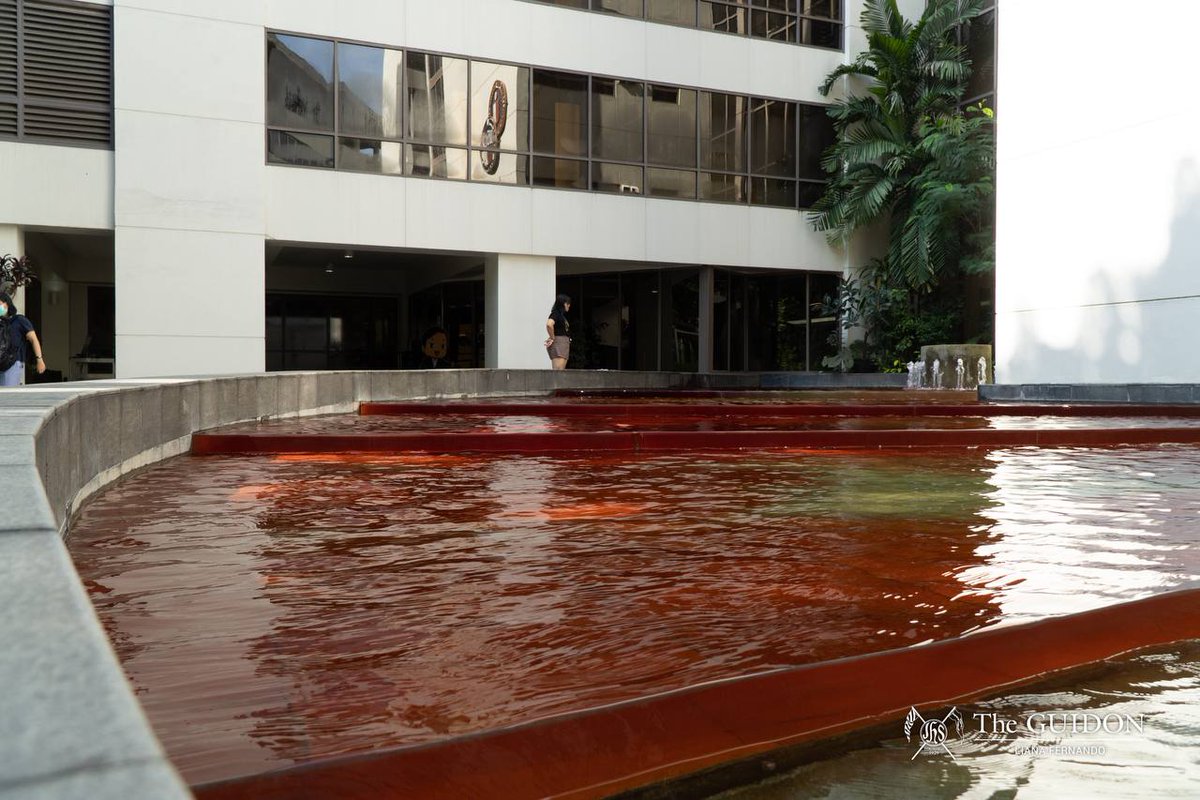 TheGUIDON's tweet photo. LOOK: The Rizal Library First Pacific Hall fountain is colored red to symbolize the blood of those lost to the injustices of the Marcos regime. This initiative is part of the Sanggunian Commission on Socio-Political Development's (CSPD) installations for the commemoration of the 51st year since the imposition of Martial Law. 

Entitled “Hugas Kamay ng Batas Militar,” the installation is done in partnership with the Rizal Library administration. This serves as a reminder of rampant historical distortion, particularly the recent proposal of the Department of Education to remove the Marcos name from discussions concerning their dictatorship.