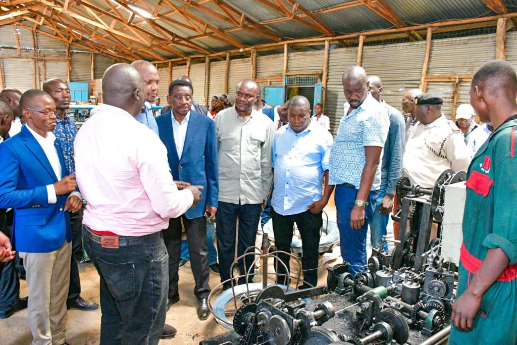 HonMoses_Kuria's tweet photo. After the colourful launch of the  Siaya County Aggregation and Industrial Park (CAIP),  accompanied by H.E Governor @orengo_james , KNCCI Nyanza Chapter National Director Ken Onditi , and Anna Ooko Business Development Manager KDC , we visited the  Nambole General Trade a local manufacturer of barbed wire, chain links, & nails in Siaya County.