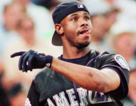 Jon_Finkel's tweet photo. Tens of millions of 1990s kids wore their hats backwards because of how cool Ken Griffey Jr. looked  

But do you know why Junior started wearing his hat backwards? 

This is a little known, but all-time great sports dad story you're gonna LOVE:

1/ We begin with Ken Griffey Sr.  

Before Junior became the smiling, charismatic face of 90s baseball...  

Senior was a stalwart on Cincinnati's famous 1970s Big Red Machine.  

He played with Johnny Bench, Joe Morgan, Pete Rose.....

2/ Ken Griffey Sr. wasn't a role player...  

He was a 3x All-Star.   

He hit .336 & was Top 10 in MVP voting in 1976.  

He won 2 World Series Rings.  

Most importantly, he was a family man...  And his son, Ken Griffey Jr., grew up in the Reds clubhouse....

3/ Like most boys, Junior idolized his dad...  

Wanted to look like him, act like him and be him...  

Even dress like him.  

But instead of putting on a suit and tie or work uniform like other kids, Junior would steal his dad's actual Reds baseball hats.  One problem....

4/ Ken Griffey Jr. was 6 when the Reds won their 2nd World Series.  

"If I put his hat on at age six, and he's got an eight and a half (hat size) and I got like a little five, it's not really gonna stay on my head," Griffey once told NBC sports...  

So he devised a solution....

5/ If Junior put the hat on forward, it would flop down and cover his face.   

Instead...  "I just turned it around because I just wanted to wear my dad's hat," he said.  

With the visor backwards, he could wear his dad's hat just fine.  

Little did he know....

6/ At age 19, Ken Griffey Jr. made his MLB debut in Seattle.  

Within a few years he'd become one of the biggest stars in sports.   

Still rocking his hat to the back...  

For many of us, our 90s icon list goes like this:  #1 Jordan #2 Griffey  

His swing. His catches. Legendary....

7/ And while millions upon millions of us wore our hats to be cool like Griffey...  

He wore his hat backwards because he wanted to be like his dad.   

And in 1990, they even hit back-to-back homers for the Mariners. Sweet!

If you loved this and it takes you back to classic Griffey memories, share right now & follow me @Jon_Finkel 

(and if all this makes you nod your head with nostalgia, sign up for my Books & Biceps newsletter for free in my bio)