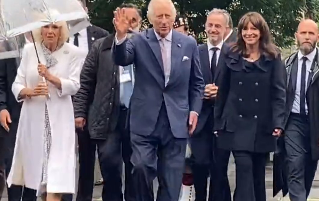 Queen Camilla is wearing shoes by Chanel and carrying one of their handbags on day two of her State Visit to France. Her coat and dress are by Fiona Clare.
