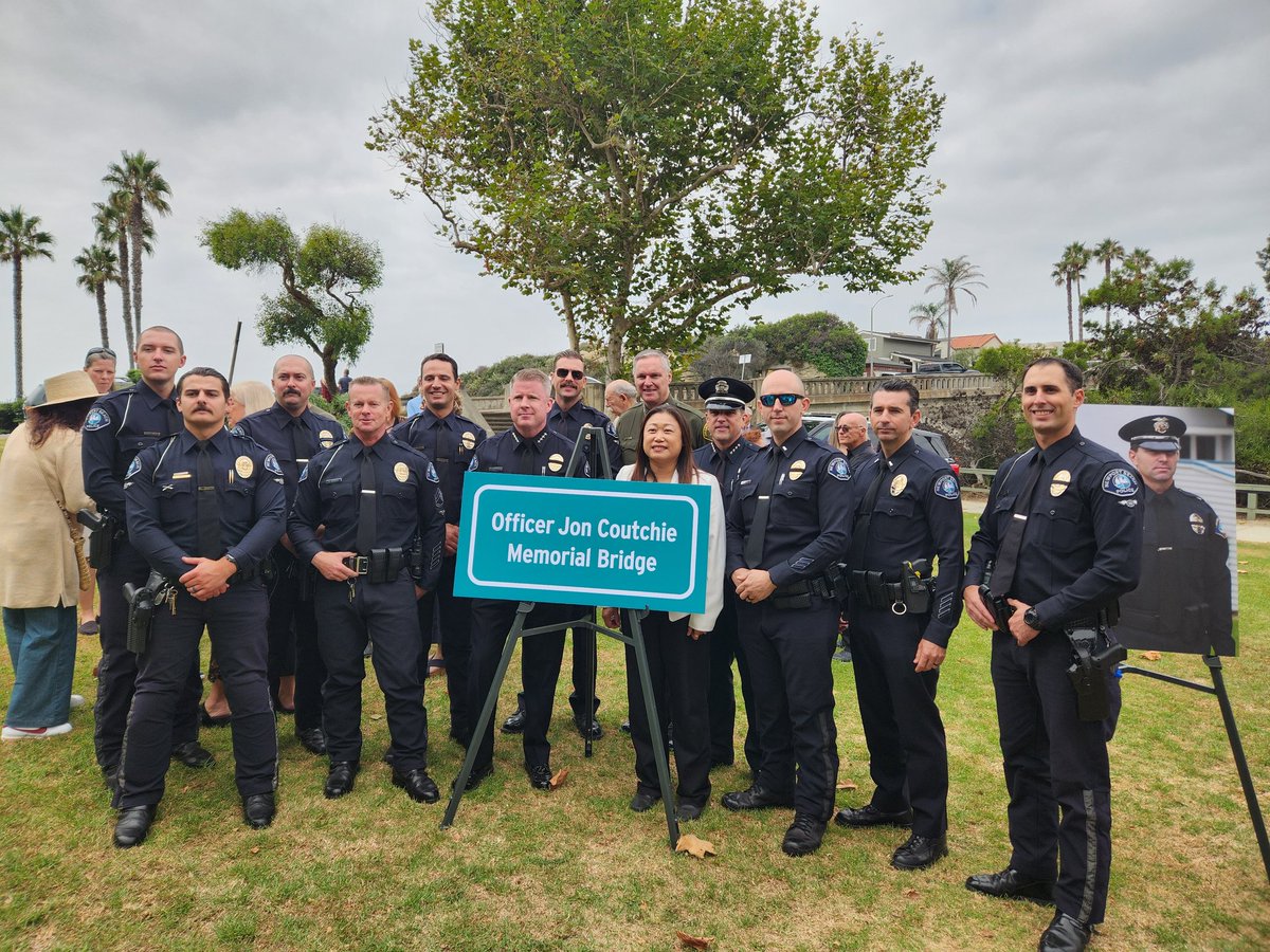 Laguna Beach police officers stand in front of a sign for "Officer Jon Coutchie Memorial Bridge." Coutchie's end of watch was 10 years ago to the day. The Aliso Creek Bridge was renamed in his honor.

<a href="/TheDailyPilot/">The Daily Pilot</a> <a href="/CarolCormaci/">Carol Cormaci</a>