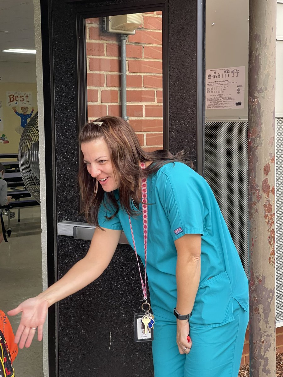 Nurse Raven greets the students with a big smile.<a href="/ElementaryHope/">New Hope Elementary</a>