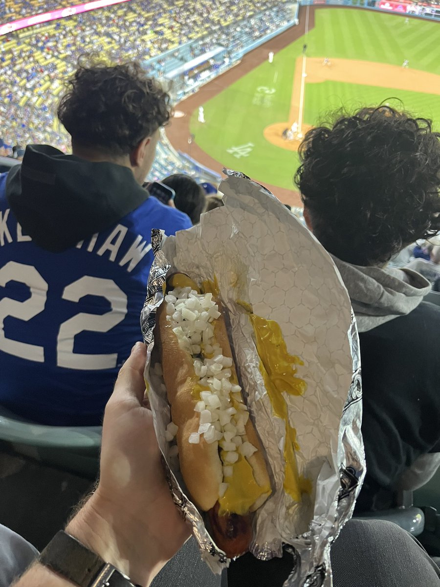 DanielNMiller's tweet photo. When Dodger Stadium reopened in 2021 after the pandemic forced its closure, there was an upsetting update: no more onions at the condiment stations. Now, order has finally been restored to Los Angeles and our hot dogs. The onions are back. (In cups. By request.) https://t.co/QuX1yw2JEE