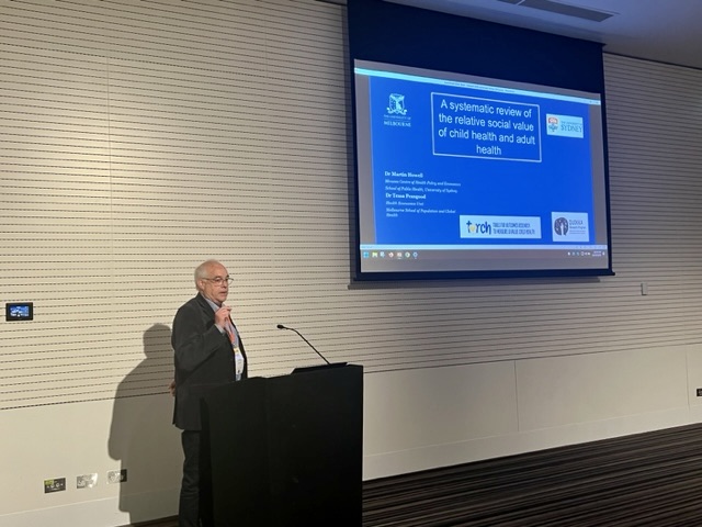 Dr Martin Howell presenting "A systematic review of the relative social value of child health and adult health" #AHES2023