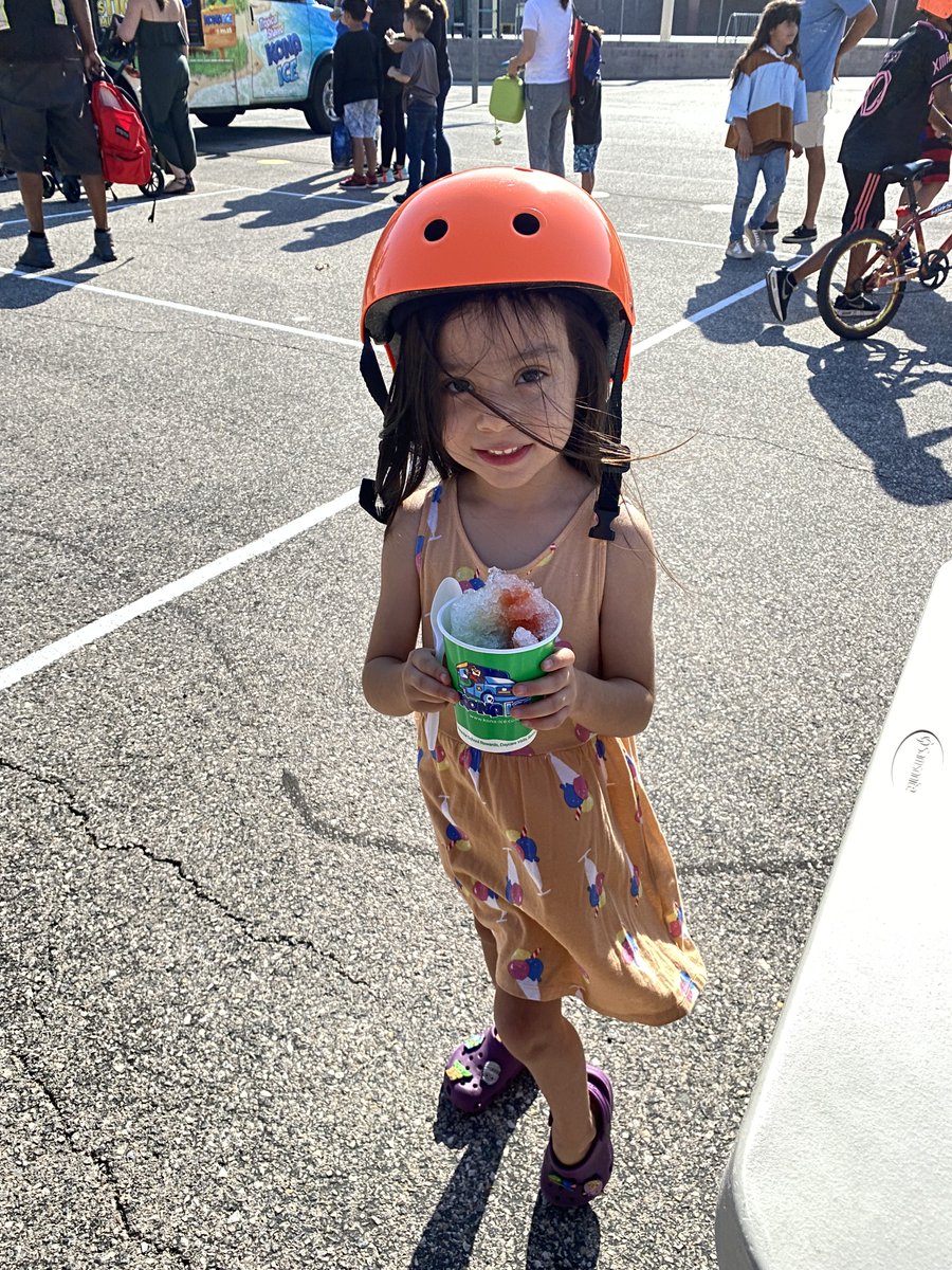 A student at Piggott Elementary enjoying her new helmet and some Kona Ice!