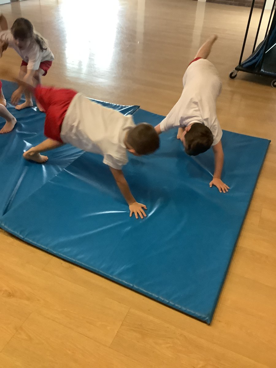 StPhilipsY3C's tweet photo. We are loving PE this half term! In gymnastics, we have been learning how to make different shapes with our bodies using balancing. Take a look at some of our fantastic partner balances. @StPhilipCEAP #teamStPhilips https://t.co/MdrofjdThE