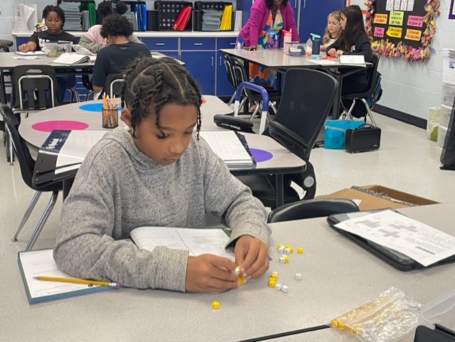 Students in Mrs. A. Corley’s Math Class apply their learning to determine how to build the perfect cube.