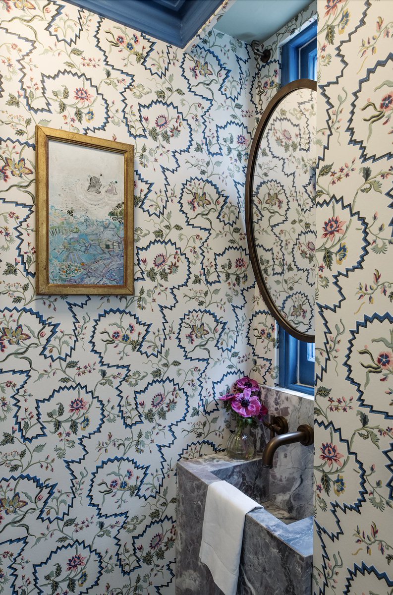 The tiny space allocated for this London powder room was a challenge. We managed to squeeze a custom-made marble sink under the window and added a charming floral wallpaper. The painting is by one of my client’s family members and adds a playful texture to the room.