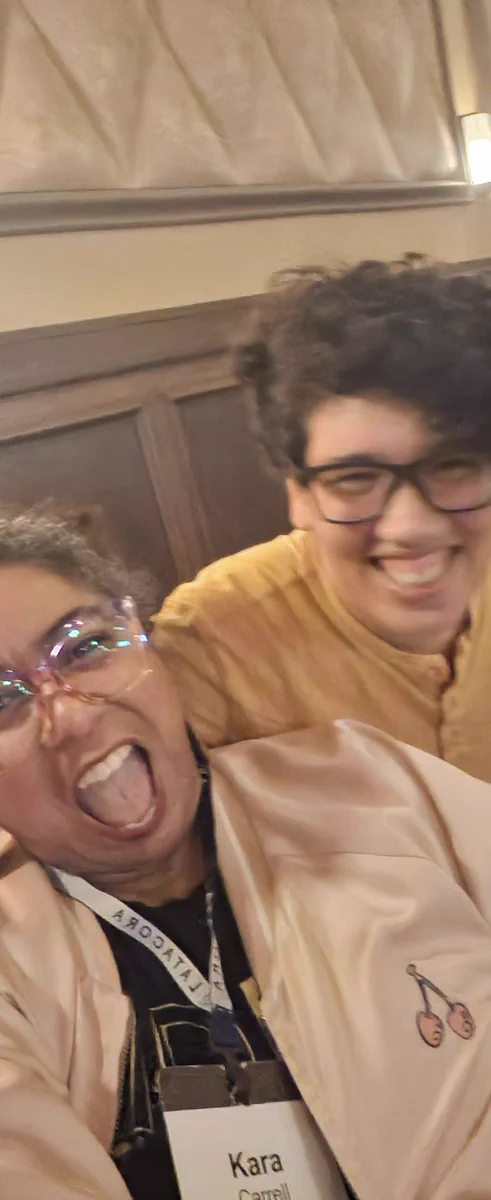 Kara trying to show off her giritgirl jacket with Julia Evans laughing beside her