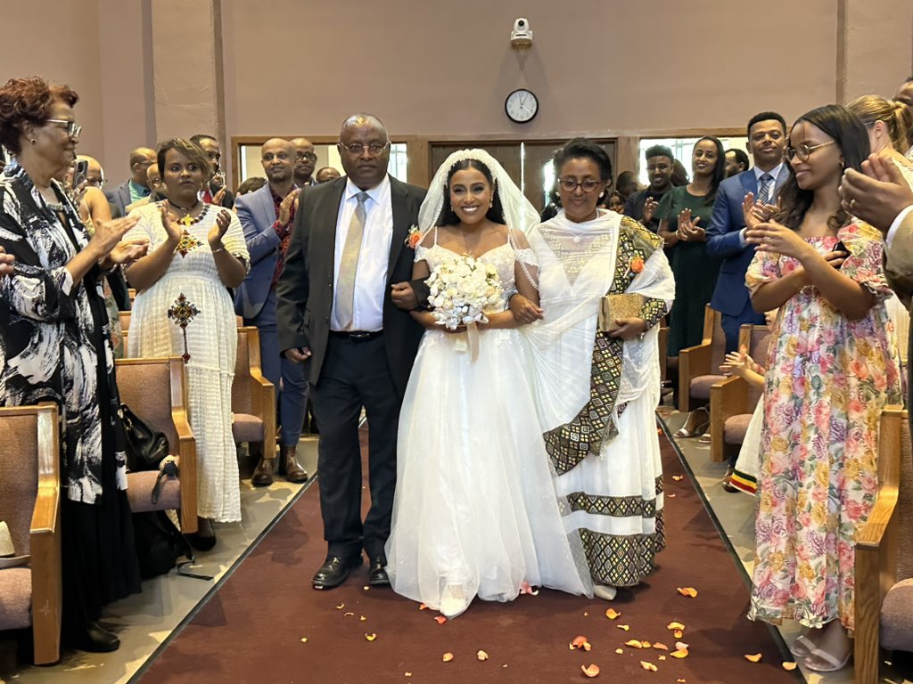 Today we married our eldest daughter to Zekarias Alemayehu in Kansas (USA). This picture of us was caught while my wife and I walked her down the aisle. May the newly married couple have a long, happy, blessed and prosperous married life #Ethiopia #USA #Kansas <a href="/DeborahKassa1/">Deborah Kassa</a>
