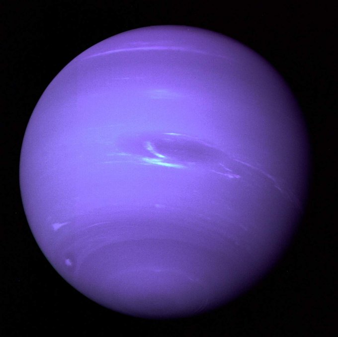 A purple planet (Neptune) fills the frame.