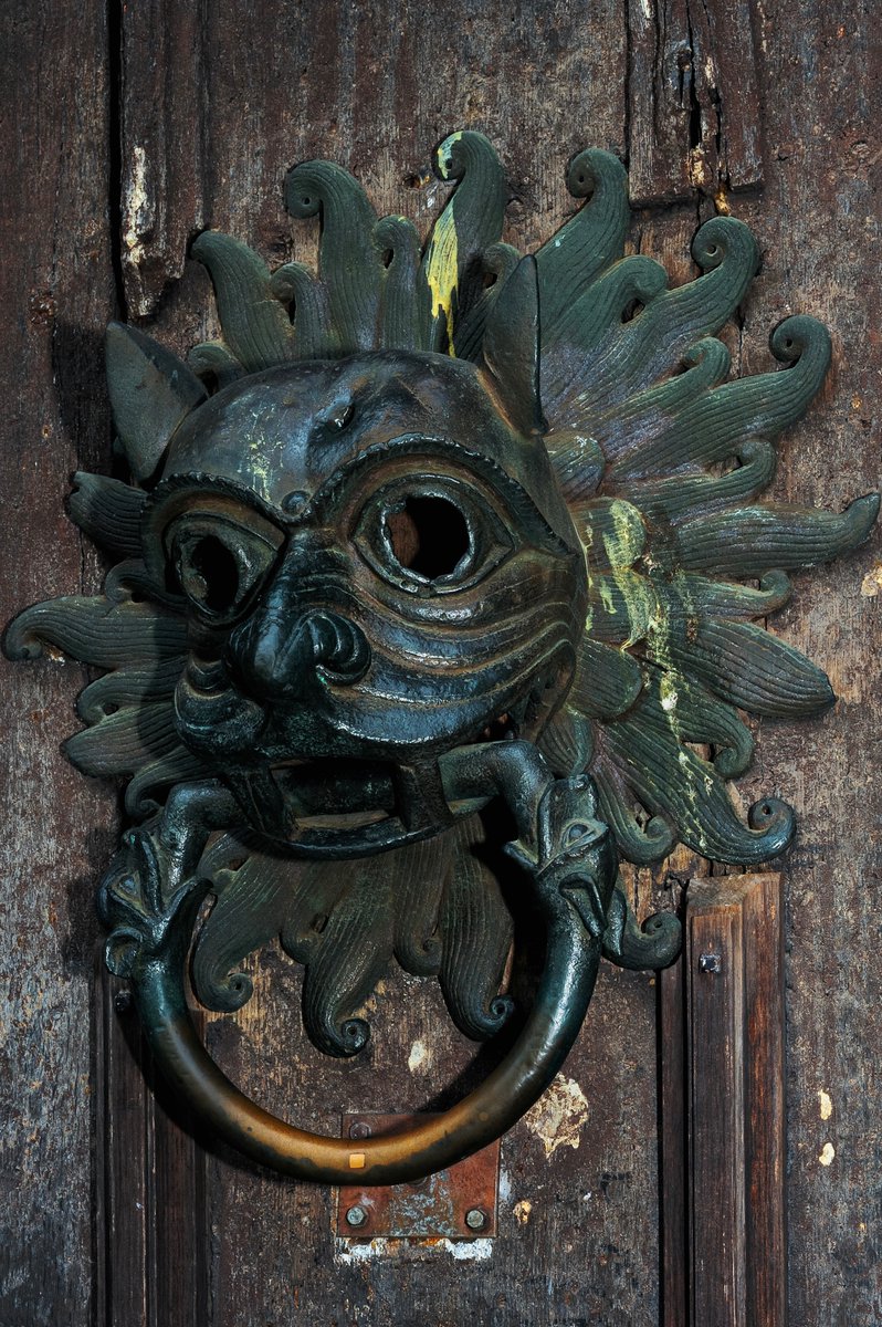 Sanctuary knocker, Durham Cathedral. Lion devours man, whose legs stick out on either side of lion's mouth and are eaten by snakes. Design based on ‘Hellmouth’, #medieval image of entrance to hell through mouth of beast.  alamy.com/portfolio/tere… #AnimalsInChurches