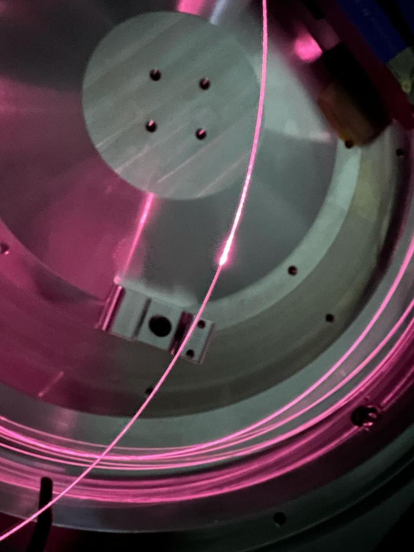 Zac (<a href="/aus_zac/">Zac</a>) finished  making the first of 3 2-micron-laser amplifers to deliver to <a href="/CGA_ANU/">CGA@ANU</a> for exciting research in next gen GW detector squeezing and coating thermal noise. The beautiful  pink glow is the 790nm pump light that's invisible to human eyes. #science #laser #gw