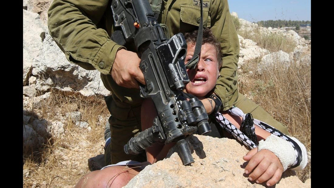 Israeli terrorists choke out small Palestinian boy and take him hostage.