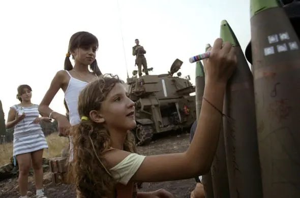 HadiNasrallah's tweet photo. Zionists sharing pictures of Palestinian children celebrating the attacks against Israel to justify their death by occupation forces thinking we forgot about Israeli children signing their names on missiles dropped on Lebanese children in 2006. https://t.co/EDbLaV4qcQ