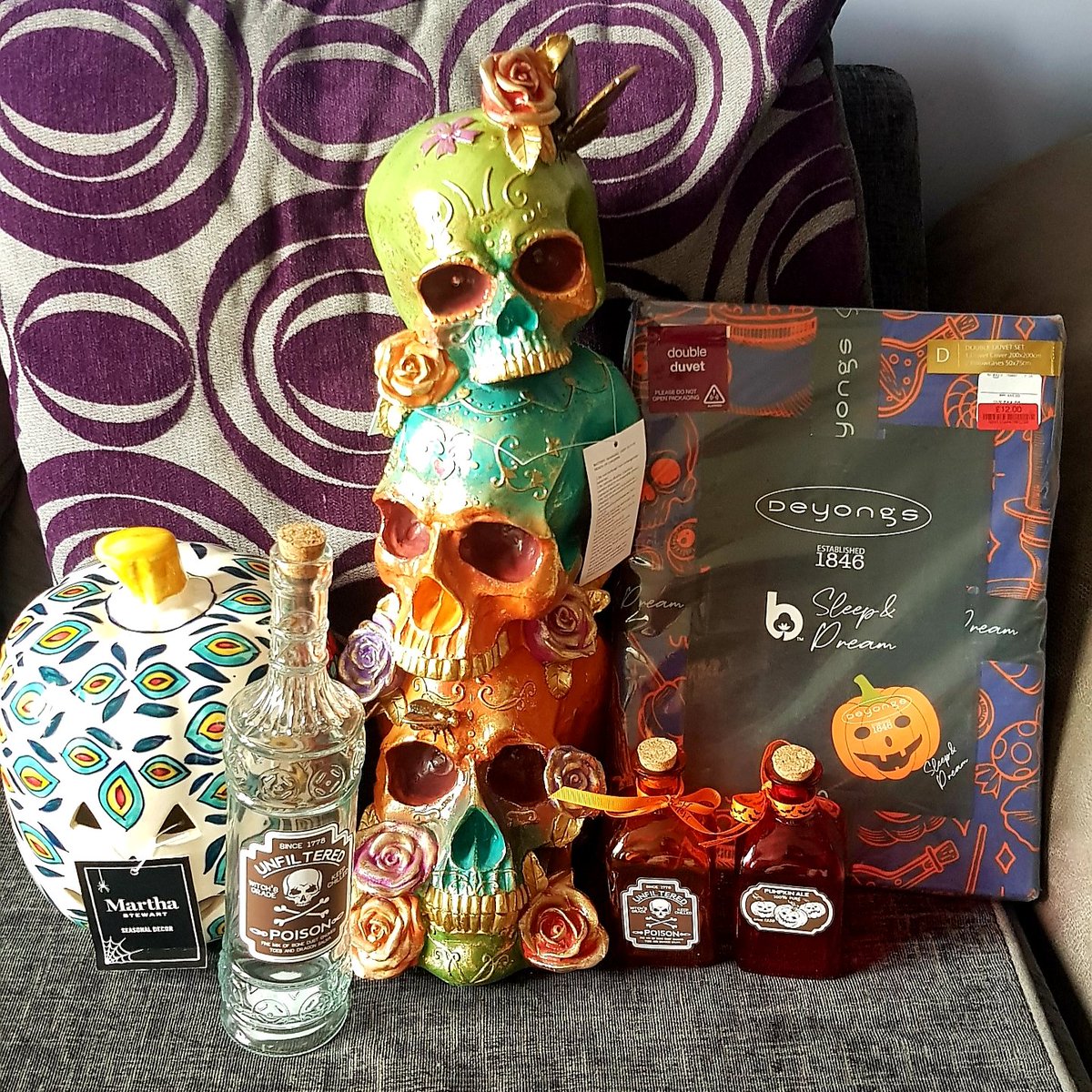Today has been Halloween decoration shopping (plus a duvet cover!).
The stack of skulls and porcelain jar are for the front door from today.
The bottle I want to fill with lights, and put out ON Halloween.
I also bought a wreath hook, for a wreath I already have...